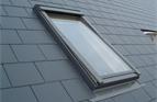 A Velux rooflight fitted in a cement/fibre slate roof