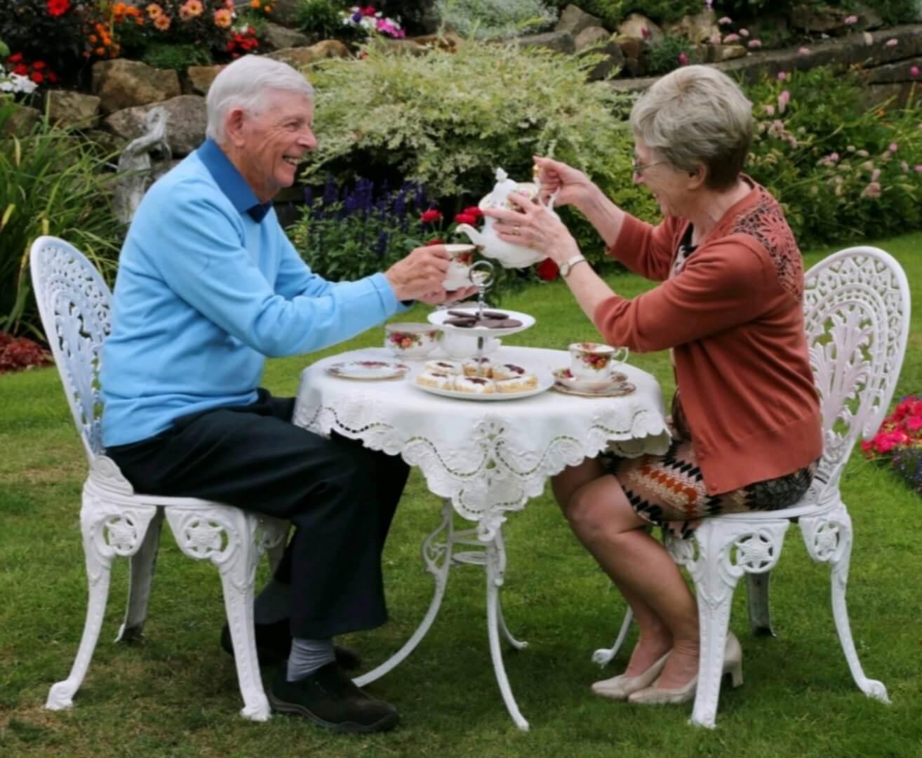 Two Adults Enjoying Tea at Table