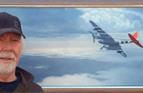 Bruce MacKay in front of his painting ' Blue Stocking Loner' a USAAF Mosquito during WW2 fling over Europe