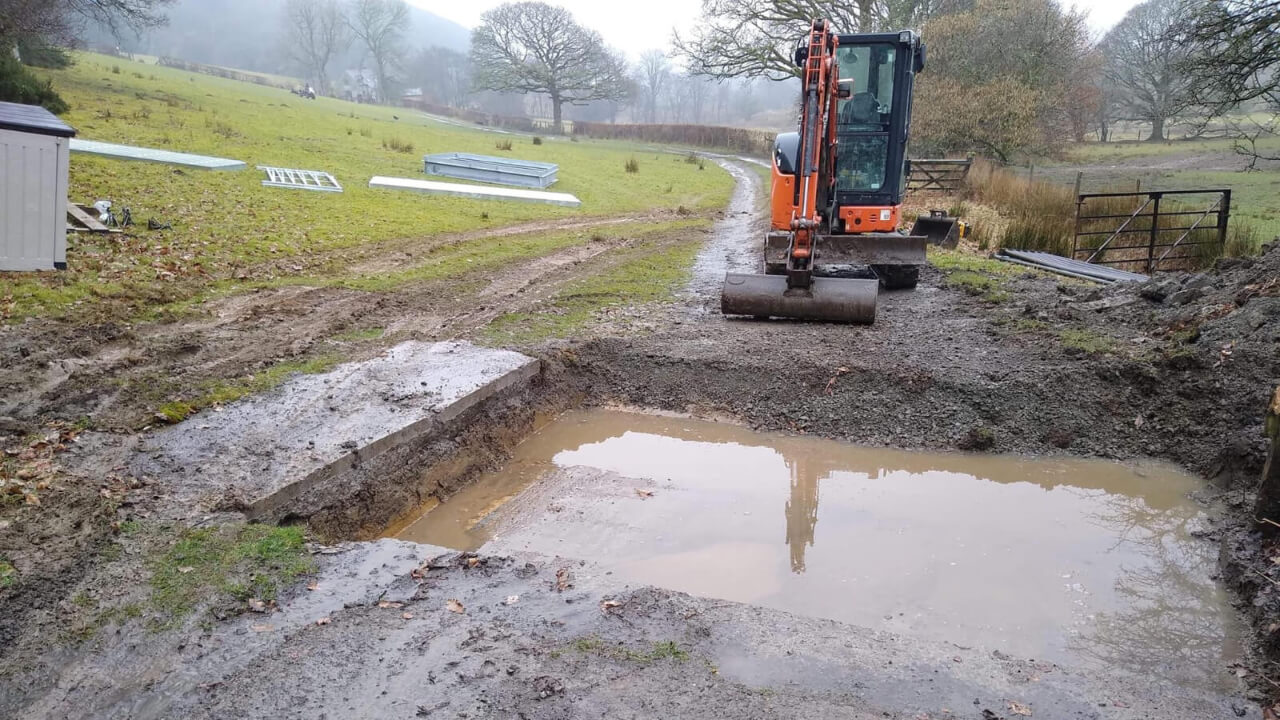 Excavator digging a pit for a Hopkins cattle grid