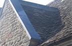 Cotswold Stone Tiled Roof. Re-roofed front Gable, and lead capped porous Stone Copings to parapet wall. Dursley, Glos.