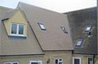 Extension roof in Painswick, Glos. Tiled in Cotswold Plain tiles with 2 Velux windows, plus 2 velux windows cut into existing roof.