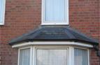 Re-roofed Bay Window in reclaimed Natural Slate. Cut and dressed lead flashings to Hips, and stepped lead flashings to wall abutment.