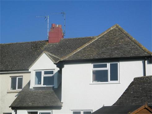 Extension Cut roof and tile. (Hipped roof and Dormer Construction) Tiled in reclaimed Cotswold Plain tiles to match existing. Cam, Glos.