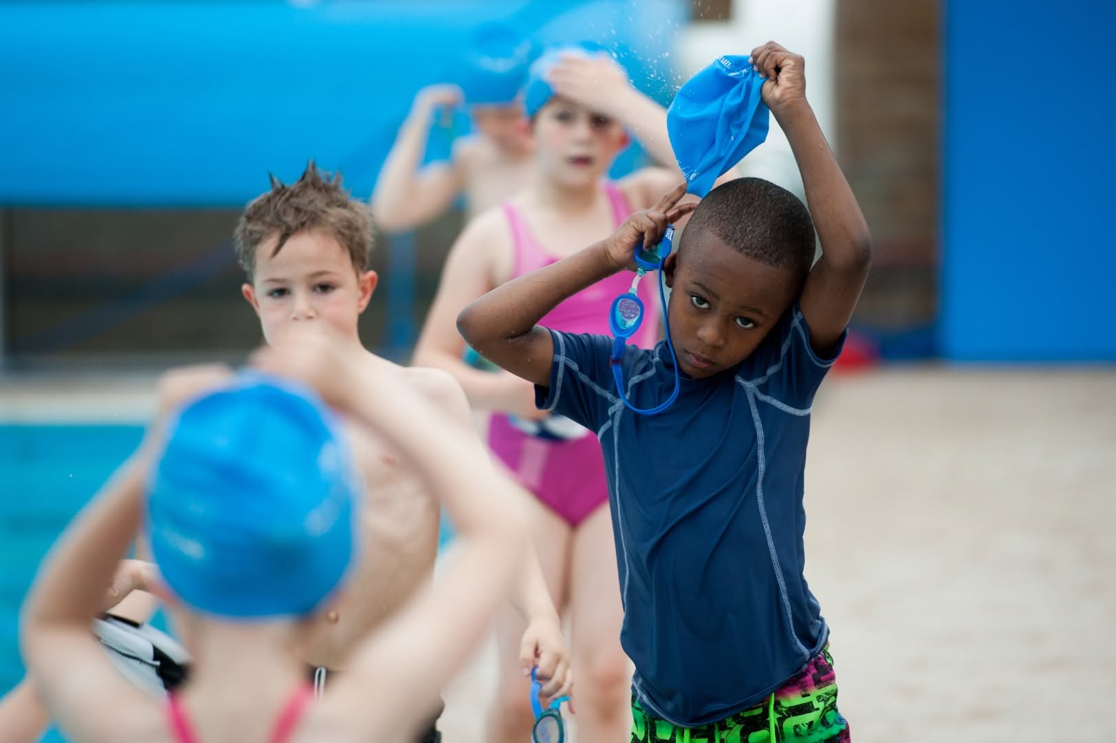 Boy-Putting-On-Swim-Hat