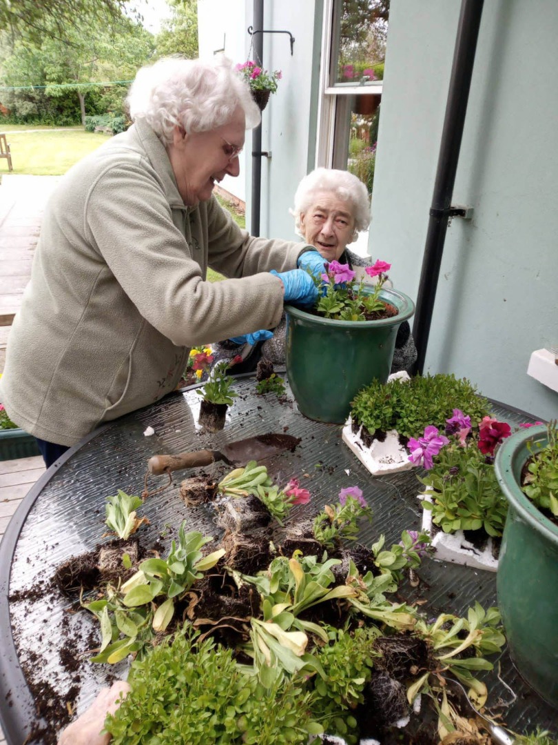 Care home residence potting flowers