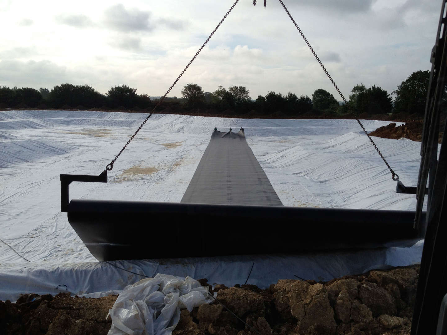 HDPE liner being rolled out over geomembrane on a Lake project in Essex