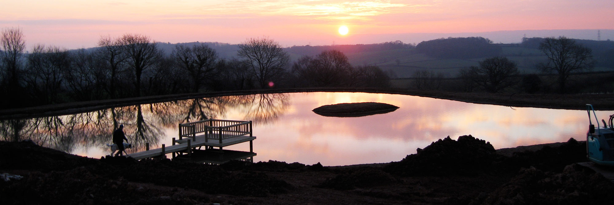 Sunrise over lake constructed in Bathelton Somerset