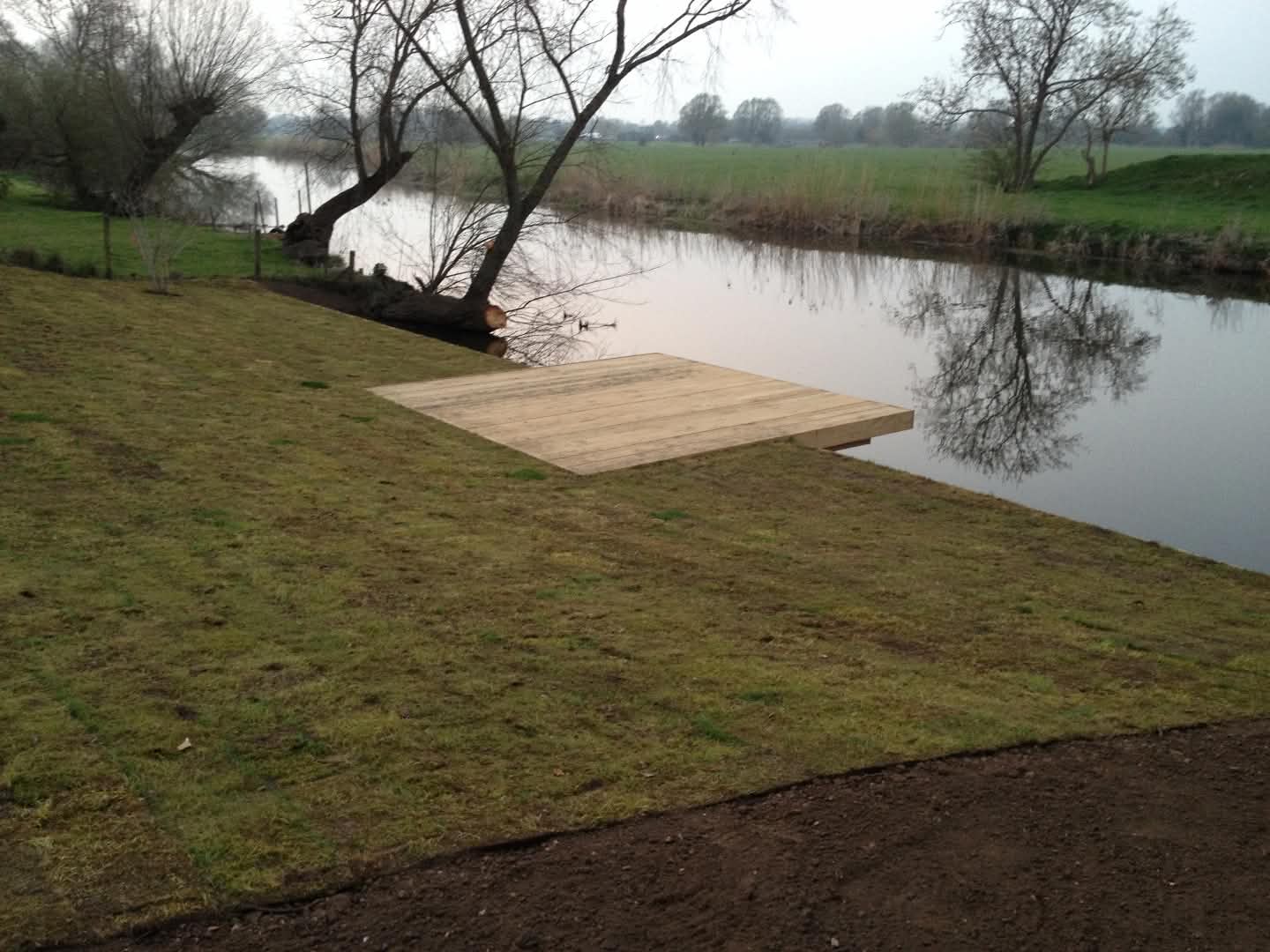 Large cantilevered deck and jetty built beside a river in Cambridgeshire.