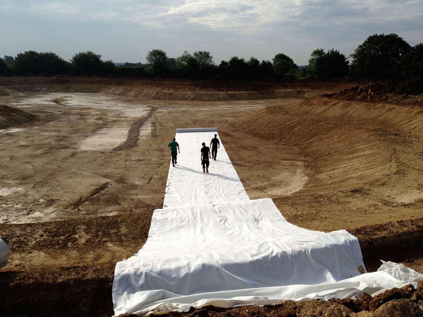 Underlay being installed in a lake