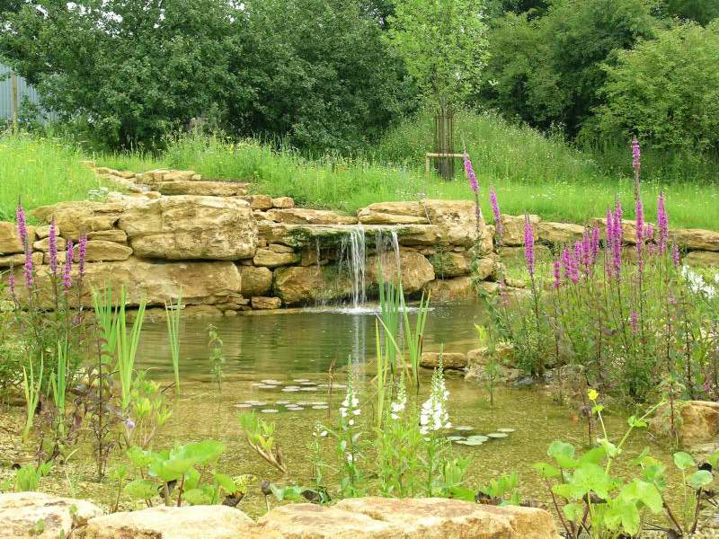 stone shelf waterfall into pond