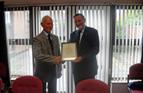 Terrance Wilson, MNA NI, receiving a Certificate of Commendation from Bob Jones, Chairman, MNWB on the occasion of his retirement from the Northern Ireland PWC, Sept'13