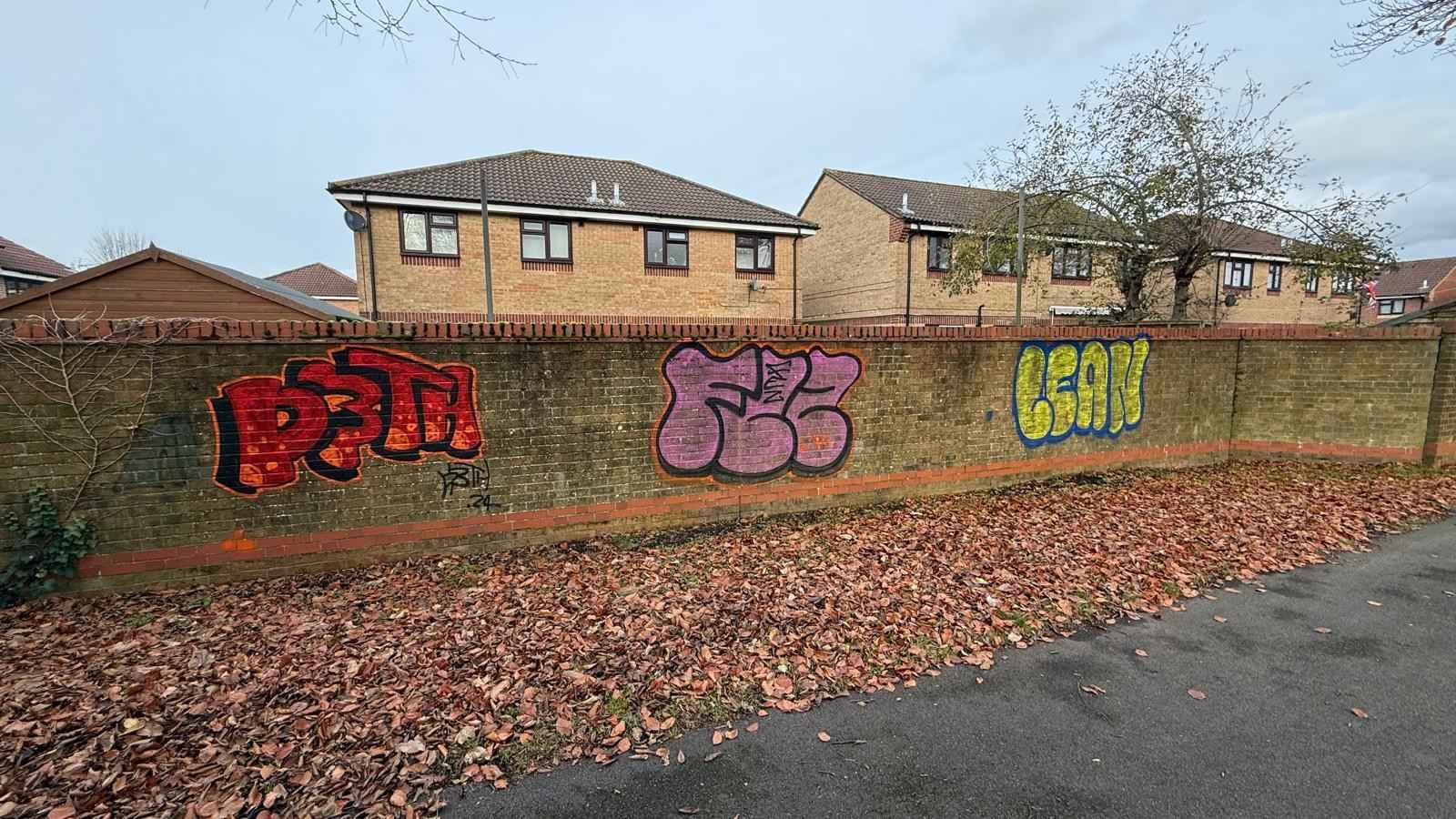 Brick fence with graffiti