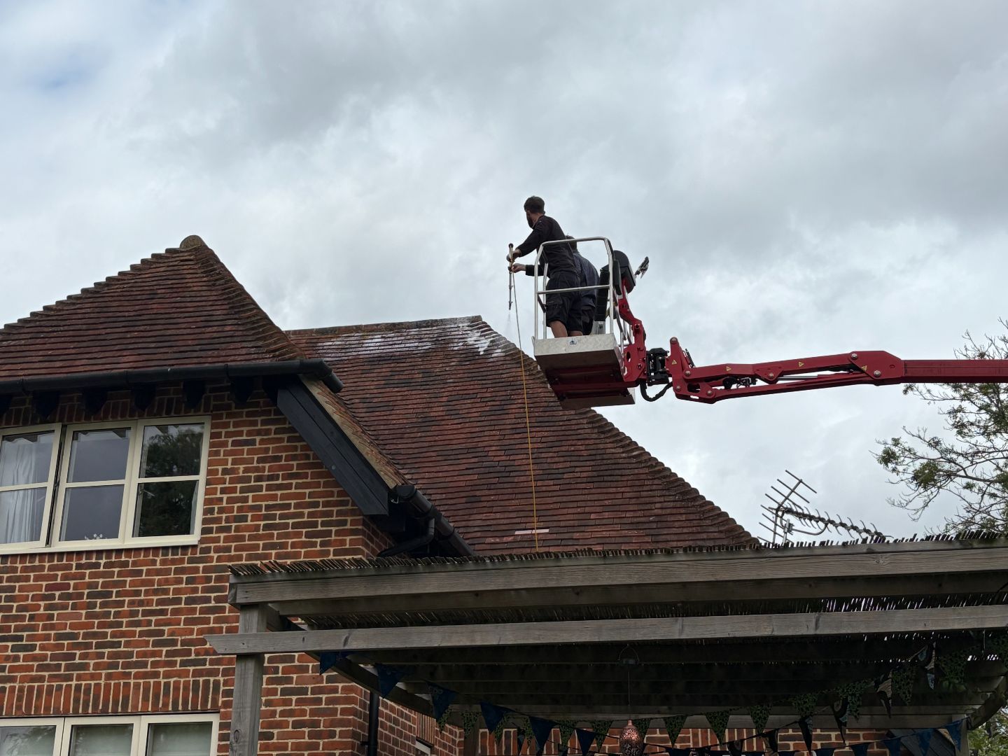 Man cleaning roof on crane