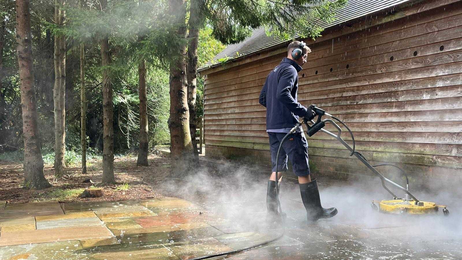 Man cleaning tiles near the house