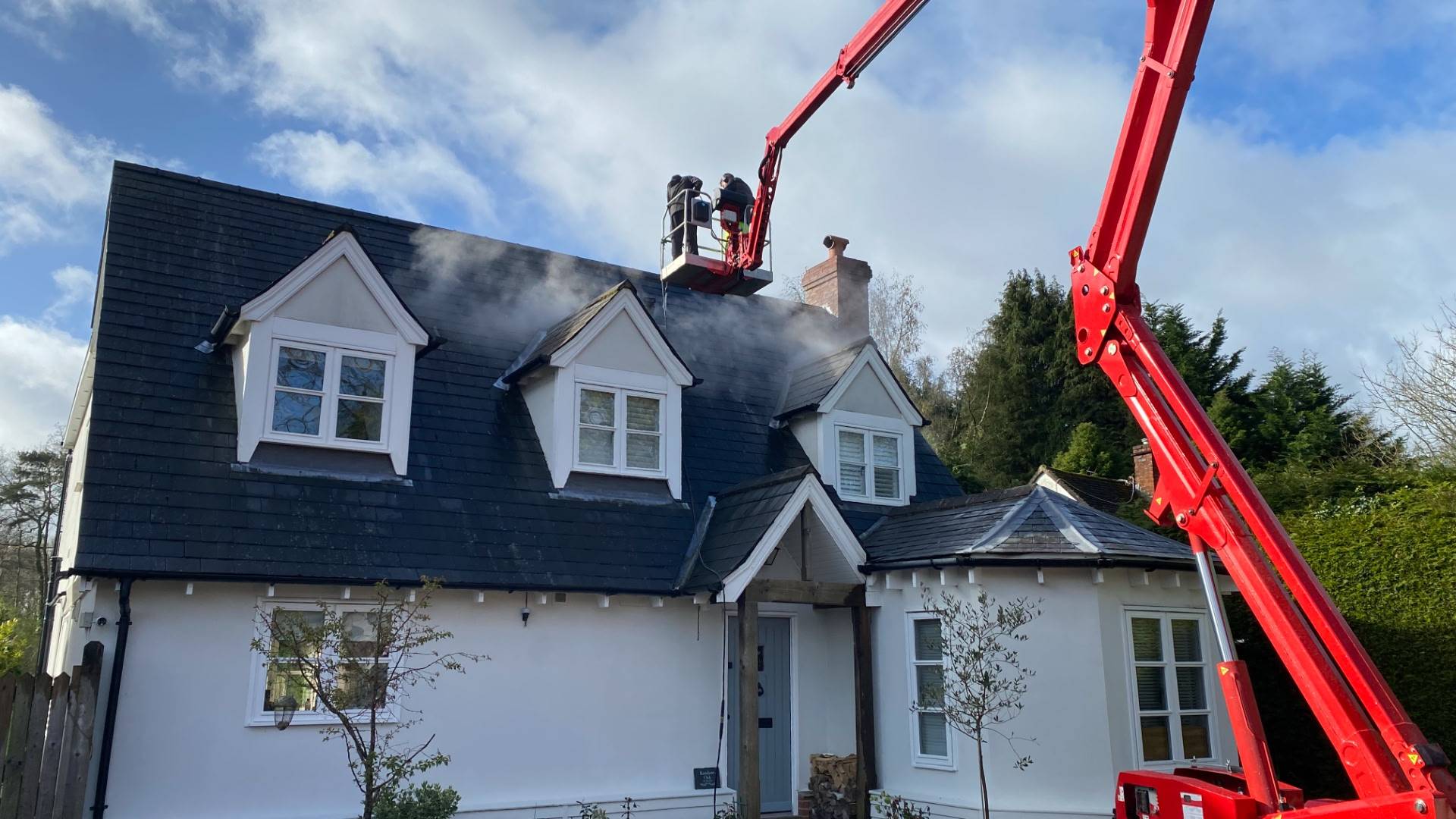 Men cleaning house roof