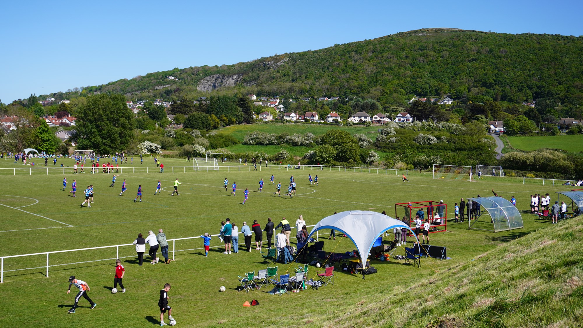 Kids passing football on the pitch