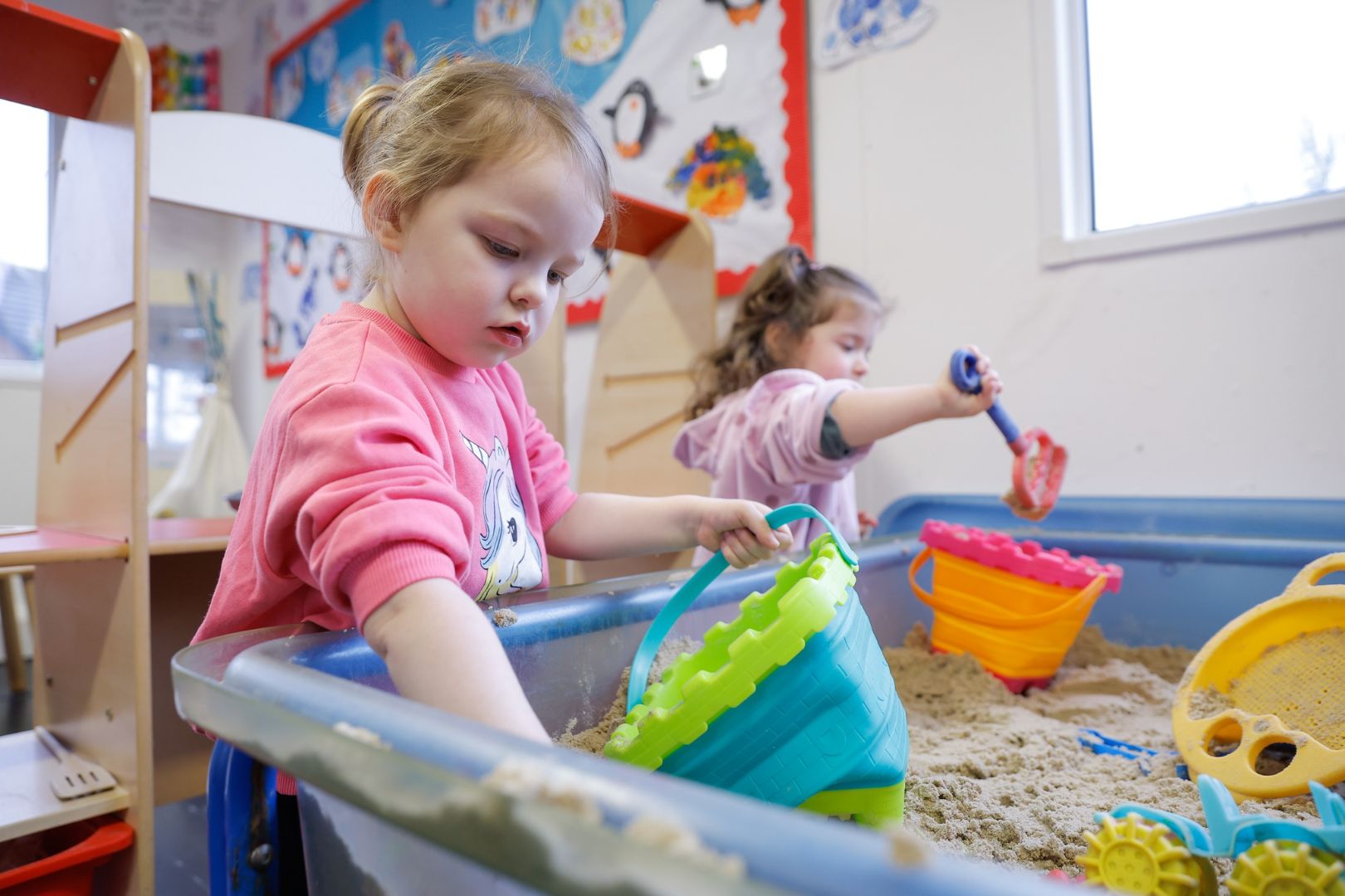 Children playing with sand and toys