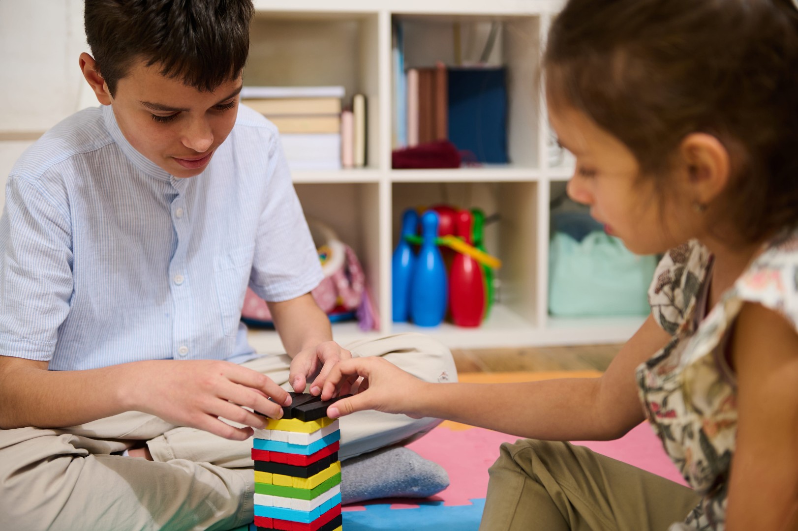Two children concentrate on stacking