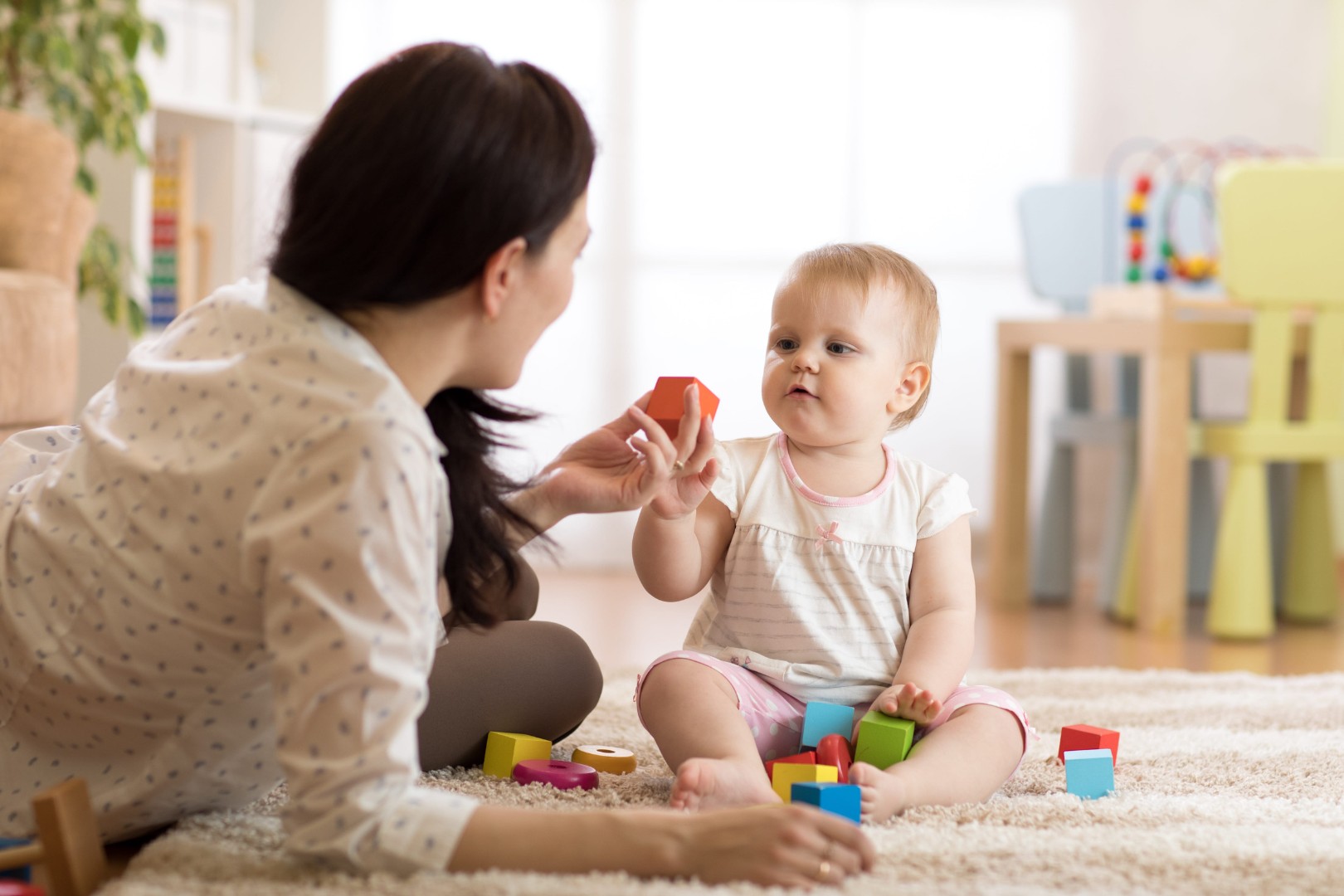 Woman with baby playing