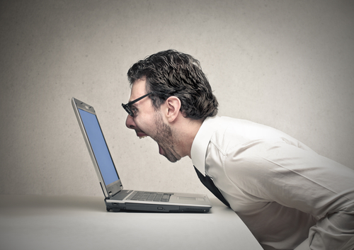 Businessman shouting at his laptop
