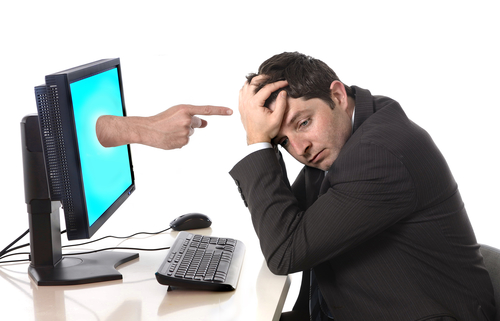 Stressed suited man in front of computer