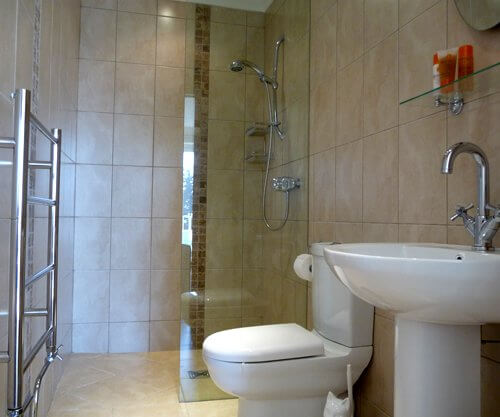 wet room style bathroom with a beige colour scheme