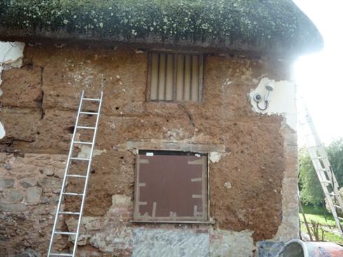 BEFORE: A grade one listed cob cottage undergoing repairs. The final result after the traditional lime mortar has been applied