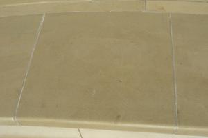 Yorkstone paving with a rounded radial edge.