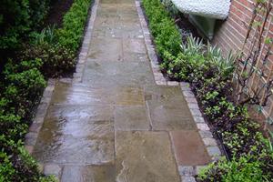 Reclaimed york stone paving and reclaimed granite setts are used to great effect on this path