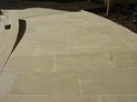 Newly sawn yorkstone coursed paving.