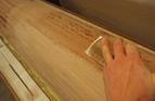 Sanding excess resin form the hull on the mould