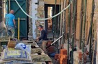 Early structural works underway, including brick and block construction and temporary support, forming part of a rear extension and wider home refurbishment project.