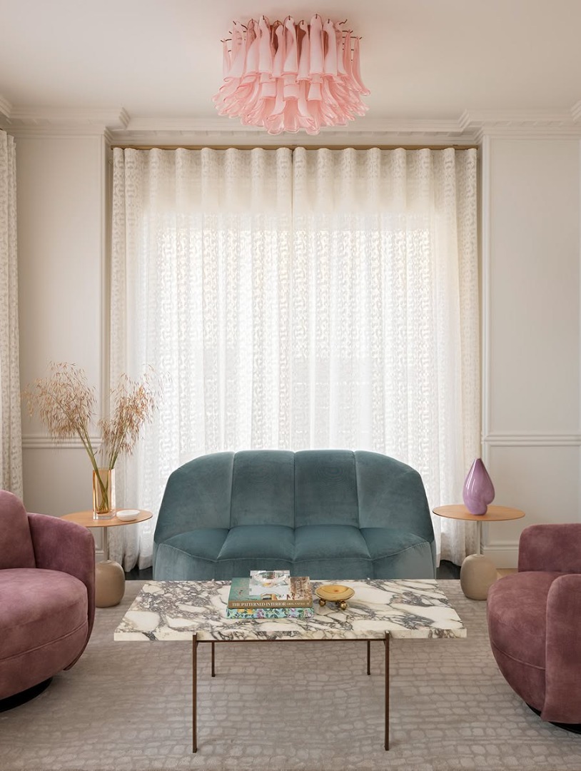 Living room with pink chairs and mint sofa