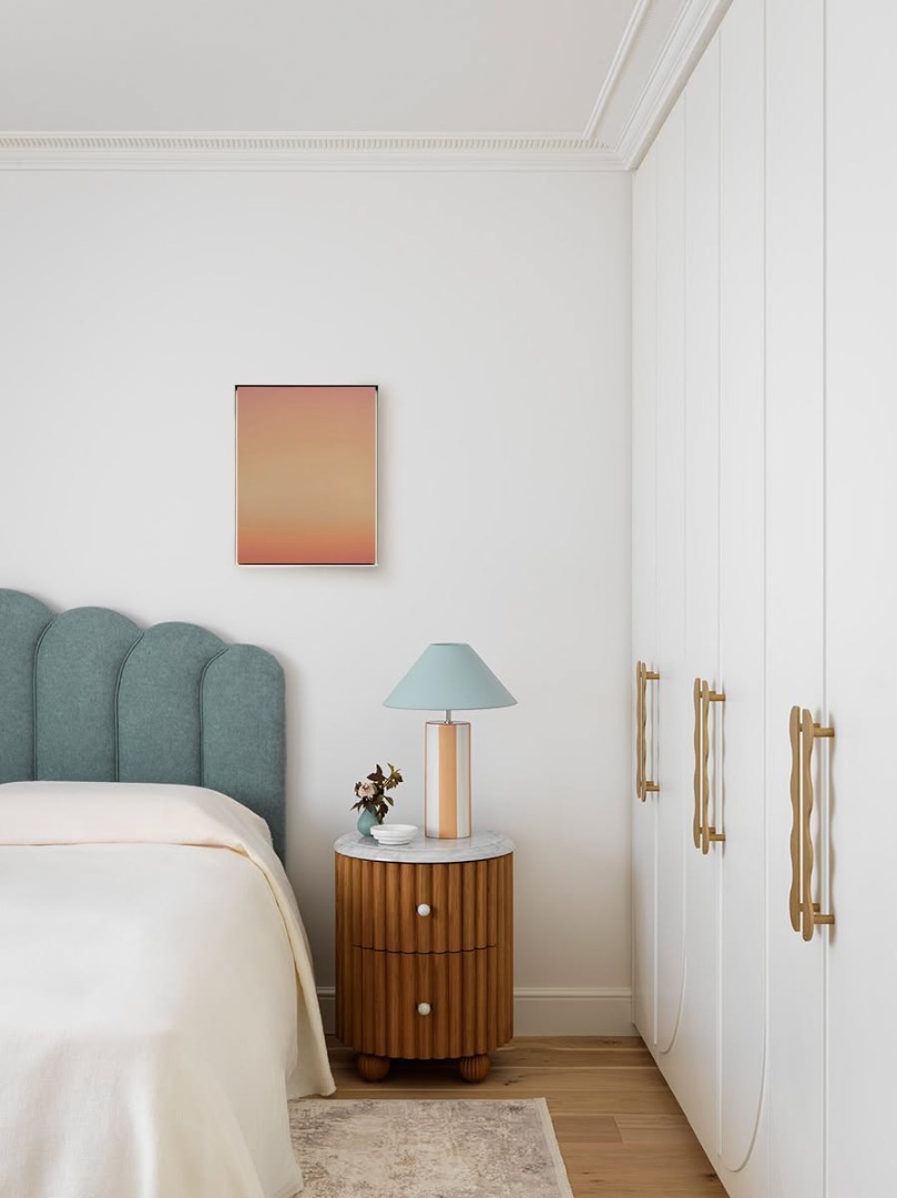White bedroom with blue accent color