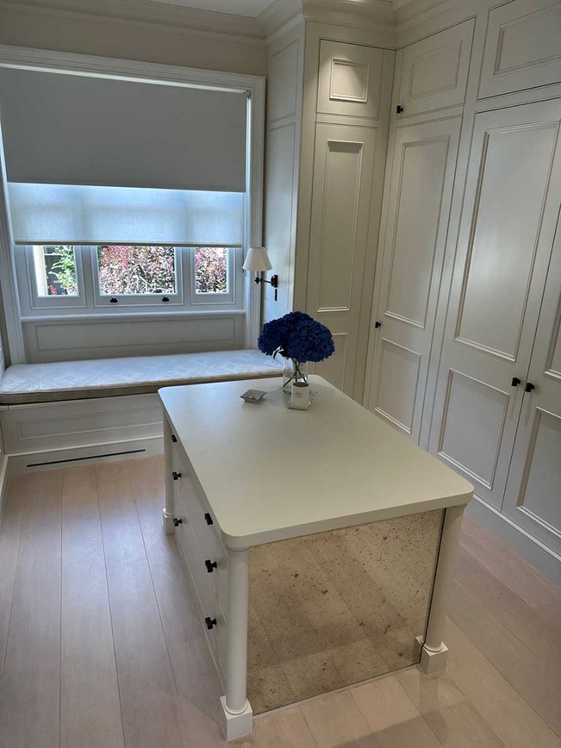 White room with wardrobes and white table