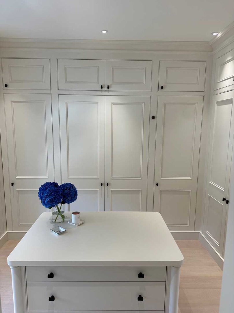 White wardrobes and white table