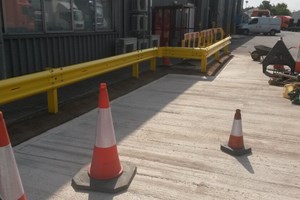 Powder coated yellow Crash barrier. Concrete in posts.  