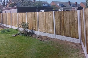 Close board fencing with concrete posts.