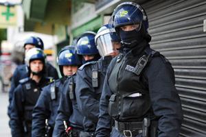 Metropolitan Police officers prepare to carry out a raid on a property on the Churchill Gardens estate in Pimlico, London during an operation where police hope to recover property stolen during the recent disturbances in the capital Thursday Aug. 11, 2011. British Prime Minister David Cameron says the government is 'acting decisively' to restore order after riots that shocked the country. Cameron told lawmakers that 'we will not allow a culture of fear to exist on our streets.' (AP Photo/Anthony Devlin/PA Wire)  UNITED KINGDOM OUT NO SALES NO ARCHIVE