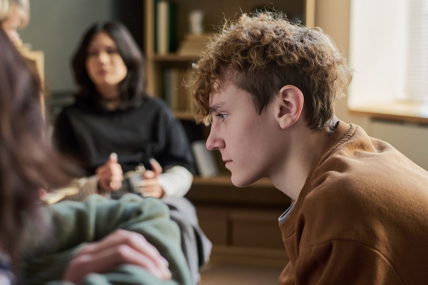 teen looks on during a group session