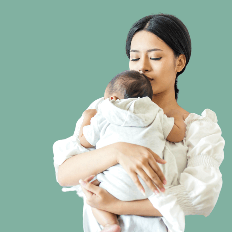 baby laying on mother