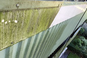 Pressure washing steel cladding close up