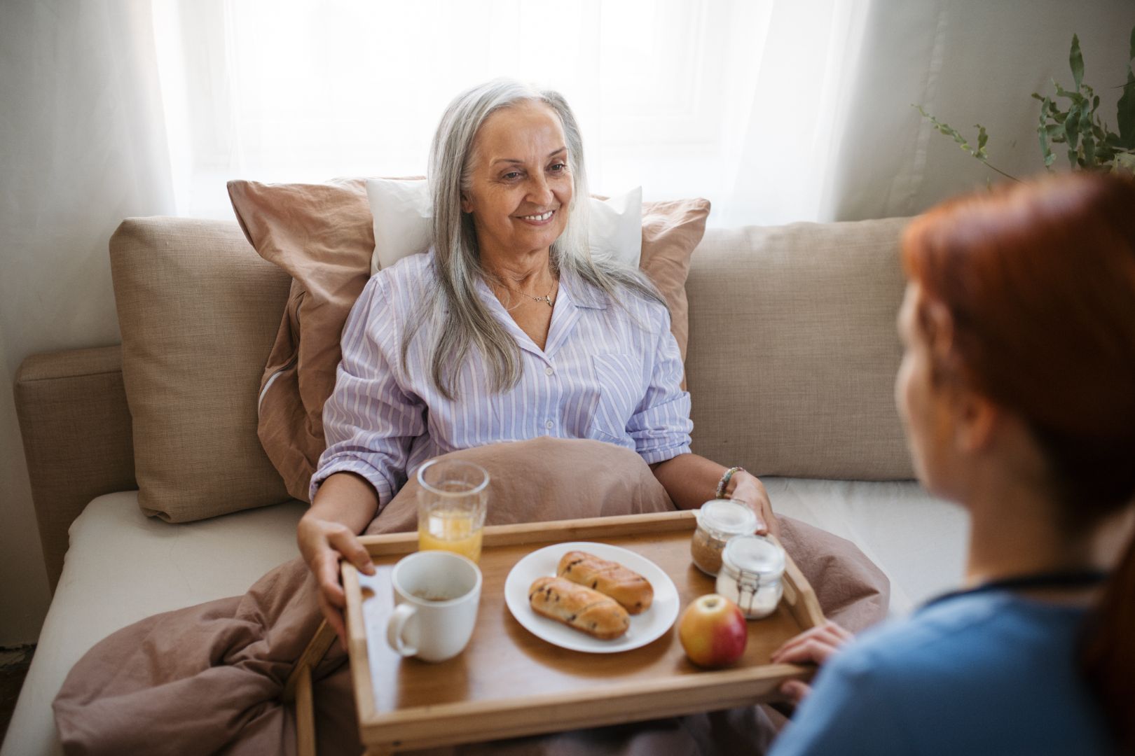 assistance in bed senior woman