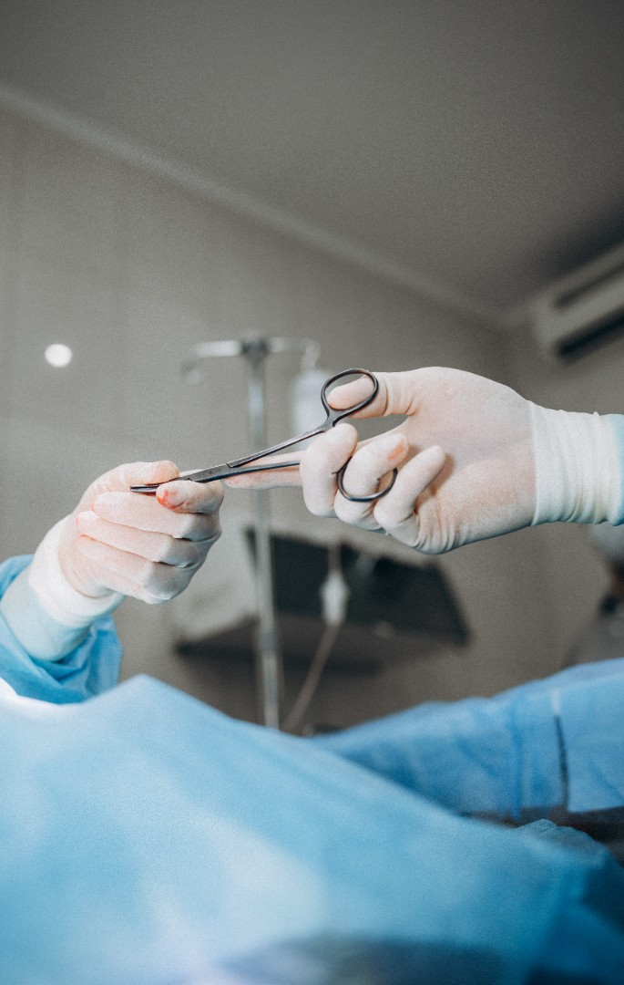 hands holding surgical scissors