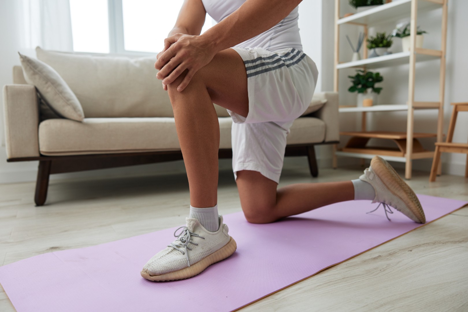 man stretching on yoga mat