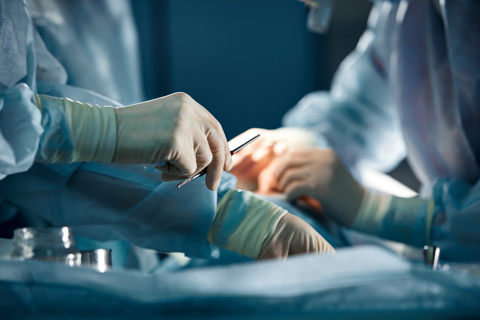 surgeons hand taking scissors