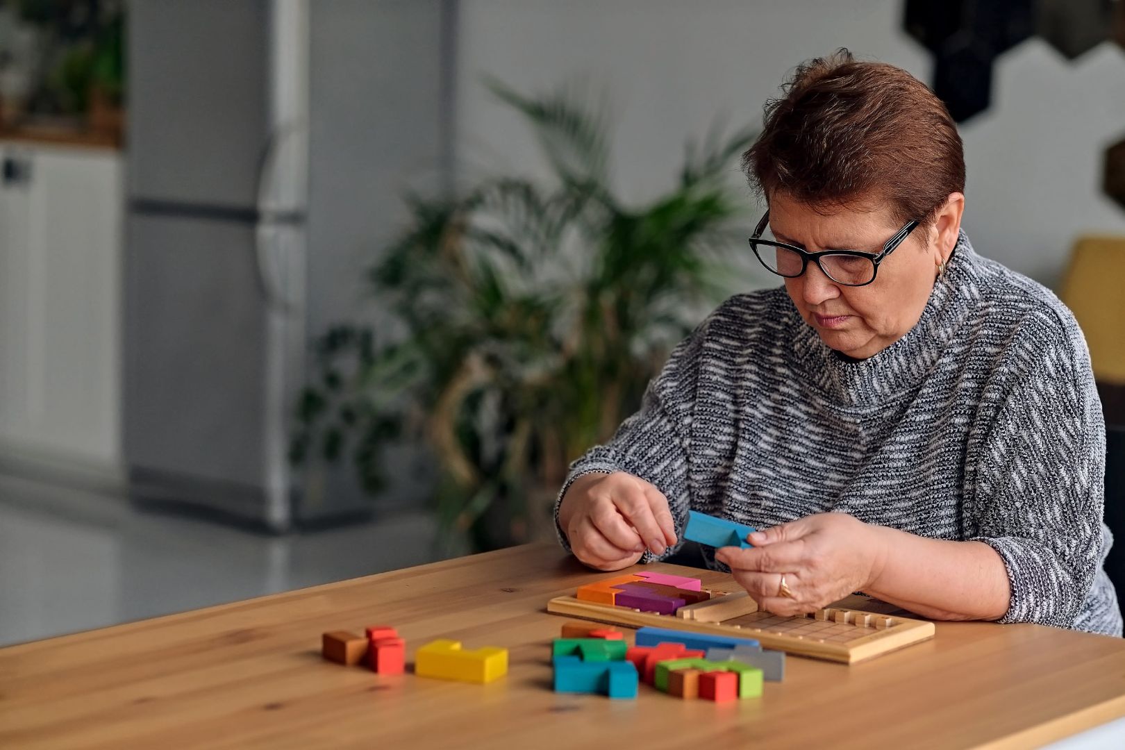 elderly people playing with blocks
