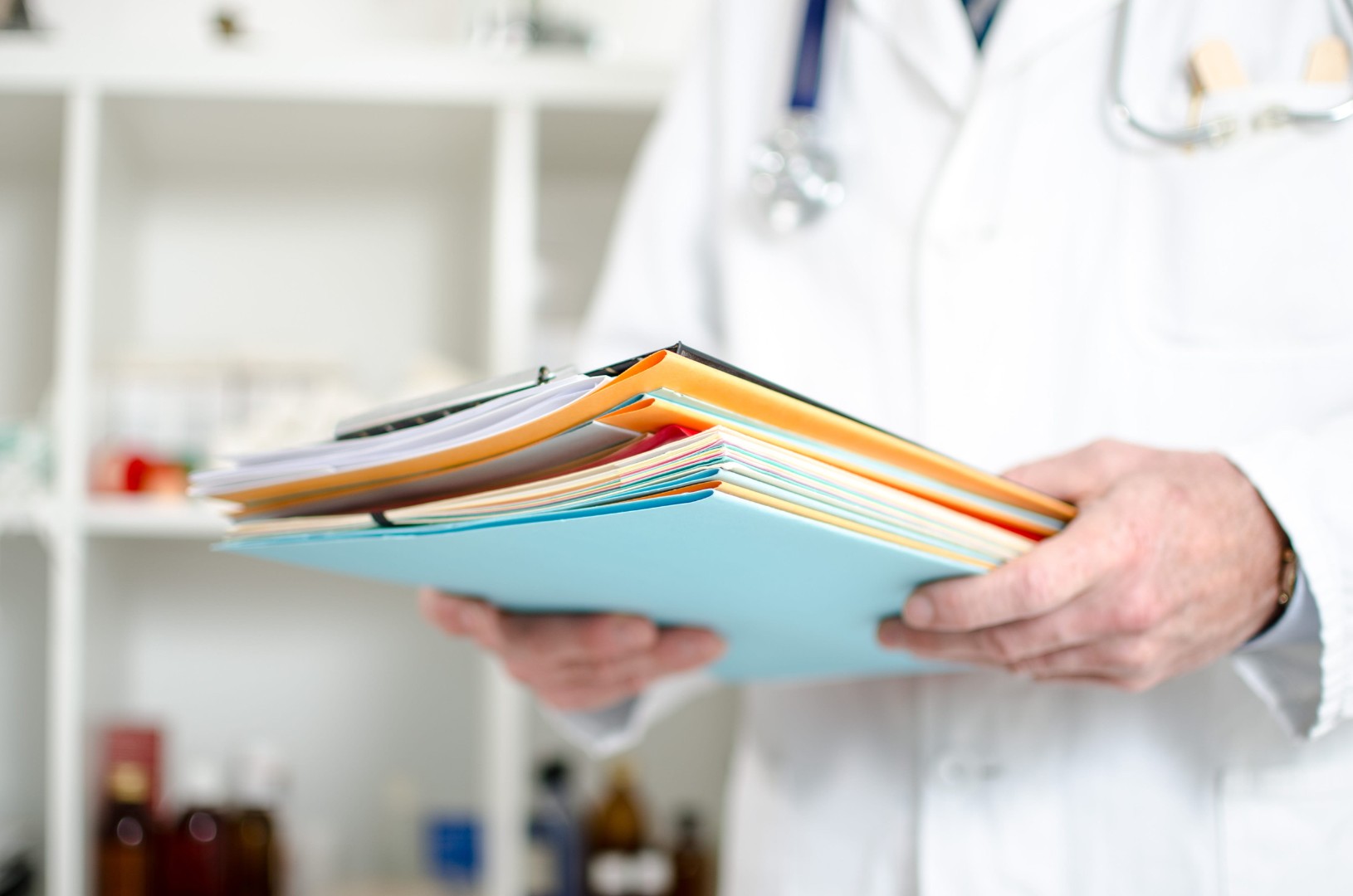 Doctor holding files in his office