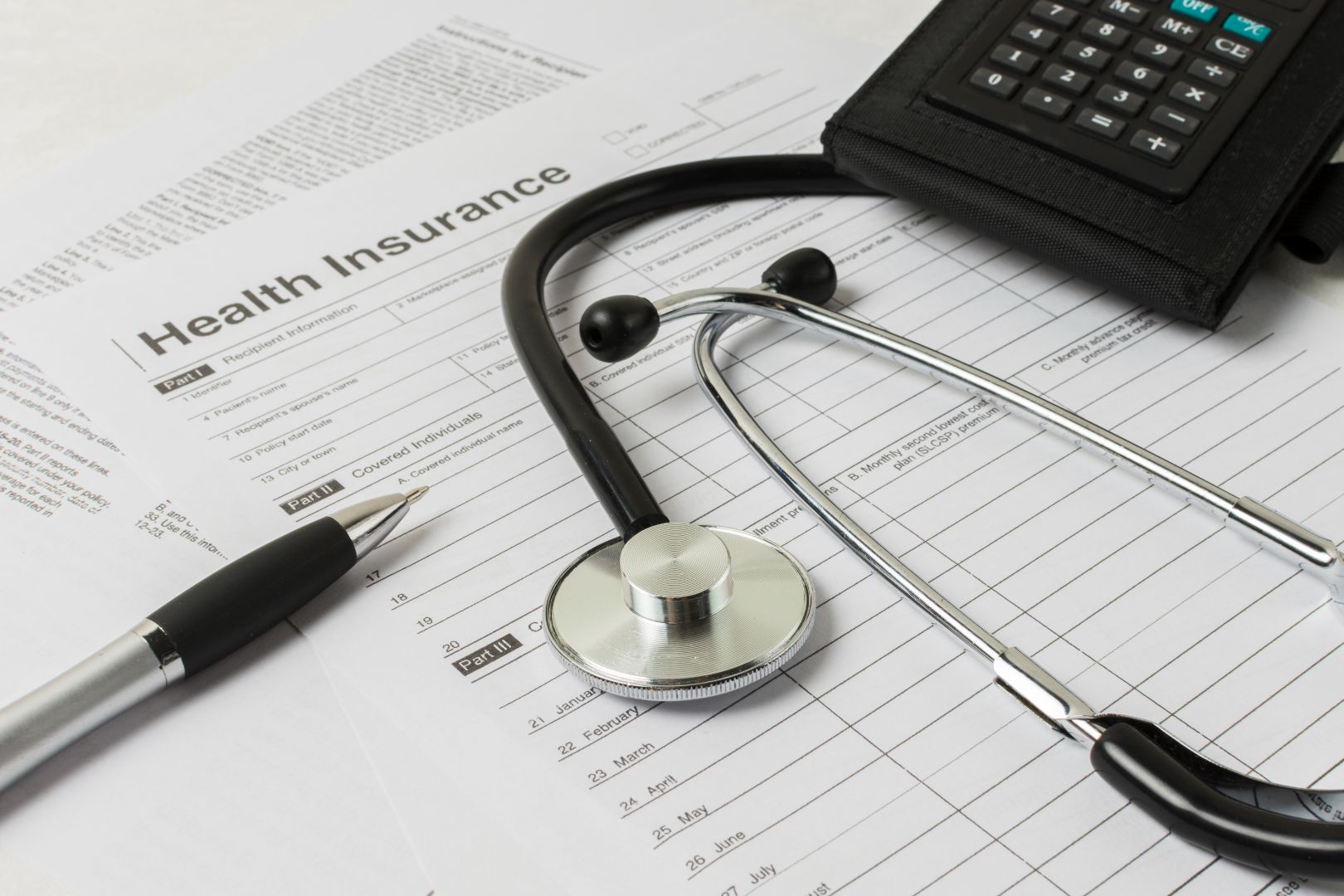 Health insurance paper work and stethoscope